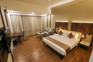 A bed or beds in a room at Spree Hotel Aurangabad