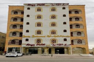 a large white building with red writing on it at Capital O 141 Golden Rays Hotel in Ibrā