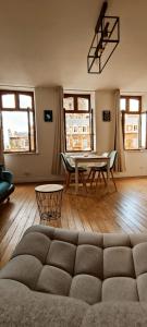 a living room with a couch and a table at Le Godefroy de Bouillon in Boulogne-sur-Mer