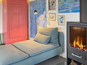 a living room with a couch and a fireplace at Holiday home Aabenraa LXIII in Aabenraa