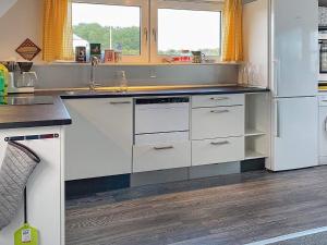 a kitchen with white cabinets and a sink at Holiday home Aabenraa LXIII in Aabenraa