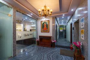 a lobby with a fireplace and a chandelier at Trimrooms Mount Blue in Jaipur