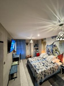 a bedroom with a king sized bed and a television at Global Home - Aparthotel - No Contact Check In in Mielec