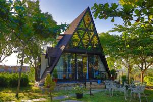 a small house with a triangular roof at Chalets Resort Masinagudi in Ooty