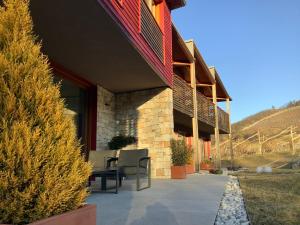 a building with a table and chairs on a patio at Agritur Verderame in Trento