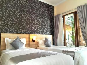 A bed or beds in a room at North Wing Canggu Resort