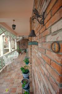 a brick wall with a sign on a patio at Hotel Paradise Road in Kutaisi