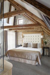 a bedroom with a large bed in a attic at Dome Hotel in Rīga