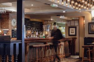 a person standing at a bar in a pub at Chapter House in Salisbury