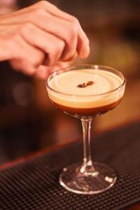 a person preparing a drink in a martini glass at Chapter House in Salisbury