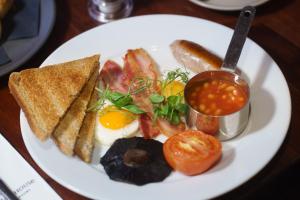 a plate of breakfast food with eggs toast and tomatoes at Chapter House in Salisbury