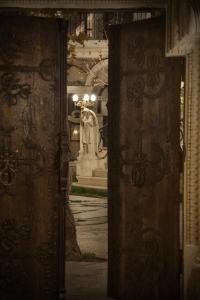 an open door of a building with a statue in the background at Sacred House in Urgup