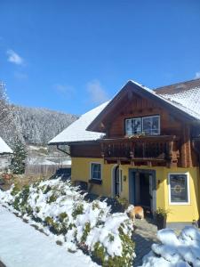 a house with snow in front of it at Appartement Aigner in Mauterndorf