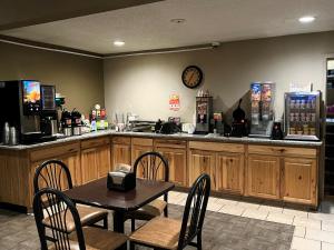 a restaurant with a table and chairs and a counter with a bar at Super 8 by Wyndham Boise in Boise