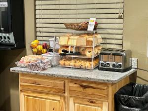 a counter with a bunch of pastries on it at Super 8 by Wyndham Boise in Boise