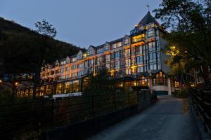 een groot gebouw wordt 's nachts verlicht bij Hotel Union Geiranger Bad & Spa in Geiranger