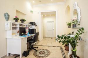 an office with a desk and a computer in a room at Pension Primavera in Vienna