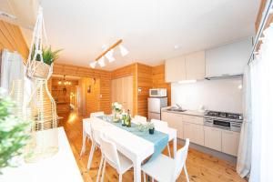 a kitchen and dining room with a table and chairs at Yokkaichi Motomachi Hotel in Yokkaichi