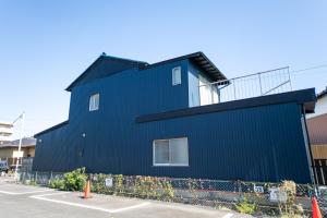 a black building with a balcony on top of it at Yokkaichi Motomachi Hotel in Yokkaichi