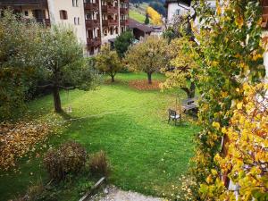 a park with a bench and trees in a yard at Molignon - Ortisei - Val Gardena in Ortisei