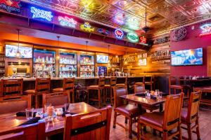 a restaurant with wooden tables and chairs and televisions at The Grand Hotel at the Grand Canyon in Tusayan