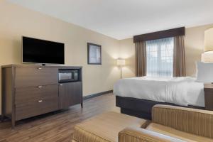 A bed or beds in a room at BEST WESTERN PLUS Saint John Hotel & Suites