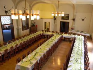 a row of tables in a room with chairs at Hotel Waldmühle in Elend