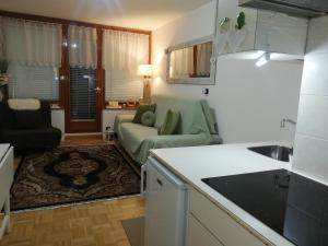 a kitchen and a living room with a couch at Condominio - Guglielmo Tell in Sestriere