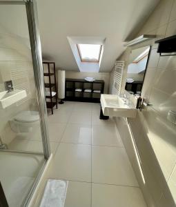 a bathroom with a shower and a sink and a toilet at Malta Premium in Poznań