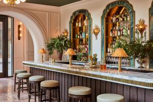 a bar in a hotel with stools at a counter at The Wall Street Hotel New York City in New York