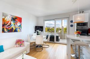 a living room with a white couch and a table at Marina Lux Split in Split