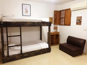 A bed or beds in a room at Pachamama Hostel Cartagena