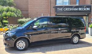 a small van parked in front of a building at Gresham Belson Hotel Brussels in Brussels