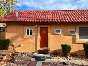 a house with a red door and a red roof at Garden of the Gods Motel in Colorado Springs