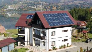 een huis met zonnepanelen op het dak bij Aqualina Colibita in Colibiţa