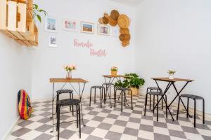 een kamer met tafels en stoelen op een geruite vloer bij Female Hostel in Faro