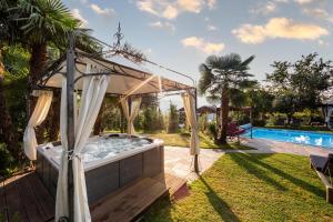 un bain à remous dans un jardin à côté d'une piscine dans l'établissement Ruster Resort, à Lagundo