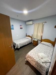 Krevet ili kreveti u jedinici u objektu Hostal Tres Hermanos