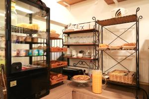 a bakery with bread and other items on shelves at Hôtel Gloria in Grenoble