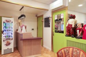 a shop with a green door and a counter at Hôtel Gloria in Grenoble