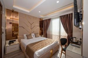 A bed or beds in a room at Luxury Airport Hotel