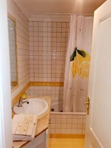 a bathroom with a sink and a shower curtain at Enjoy Beloura! in Sintra