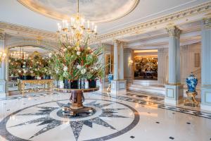 a large lobby with a chandelier and flowers on the floor at Four Seasons Hotel des Bergues Geneva in Geneva