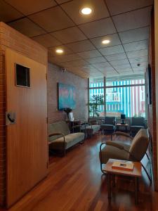 a waiting room with couches and chairs and a table at Costa Nova Hotel in Costa Nova