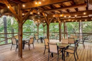 a dining area with tables and chairs on a wooden deck at Best Western Inn of the Ozarks in Eureka Springs