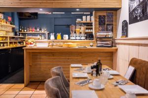 a dining room with a table and a counter at Le Relais de la Calèche in Le Beausset