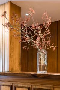 a vase with flowers in it on a table at Hotel Emporda in Figueres