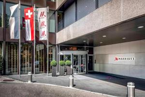 un gran edificio con banderas delante en Zurich Marriott Hotel, en Zúrich