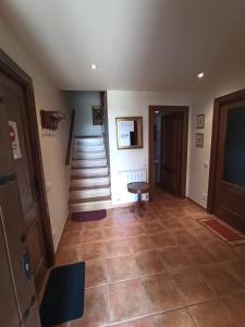 a hallway with a staircase and a room with a tiled floor at Chalet en el Pirineo de Aragón in Neril