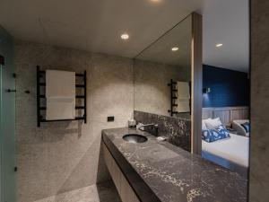 a bathroom with a sink and a large mirror at The Executive Inn, Newcastle in Newcastle